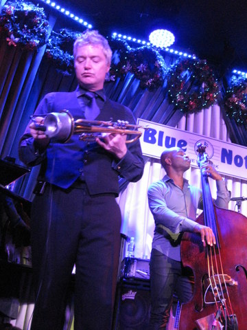 Digging the music as he attaches his mute. (December 27th) He asked his tour manager to bring his mute on Jan. 6th...he had left it upstairs in the Blue Note's musicians' lounge.