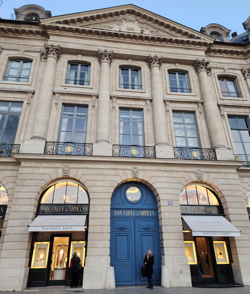 Rory stands in front of the Baroness Pontalba mansion that was converted over the years into this august jeweler, Van Cleef & Arpels., Place du Vendame, Paris. The buying and selling of buildings of wealth increases their value (Carole Di Tosti)
