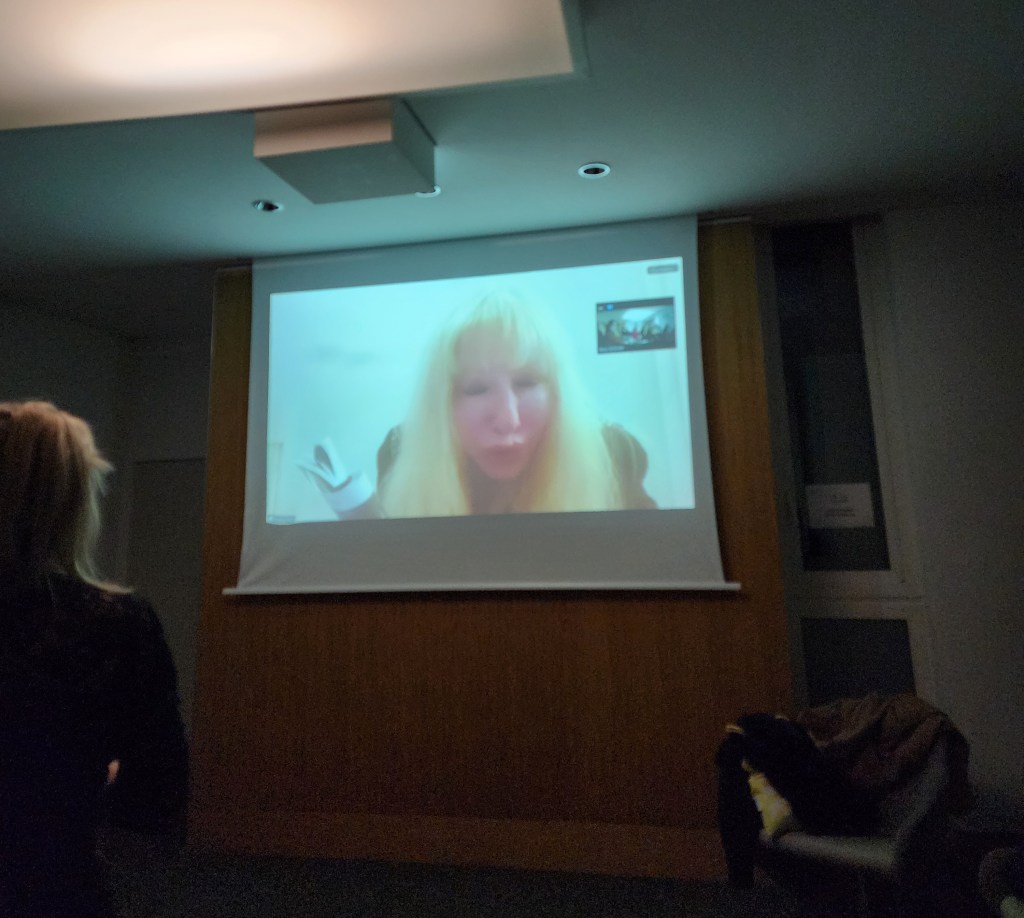 Rosary is in New Orleans. But via Zoom, she is present to dramatize why the audience shouldn't get involved with such a haunted guide, reading from the intro (Carole Di Tosti)