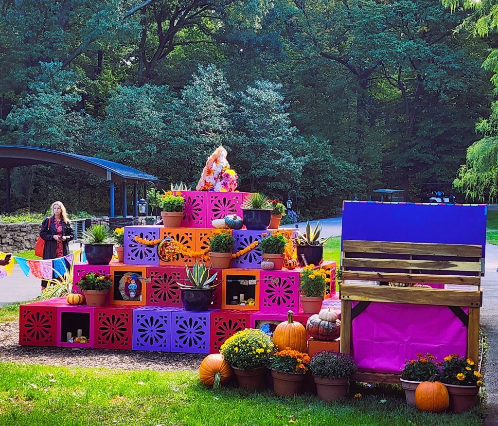 Colorful multi-tiered ofrenda (altar of remembrance) and the table of remembrance, 'Dia de los Muertos,' NYBG (Carole Di Tosti)
