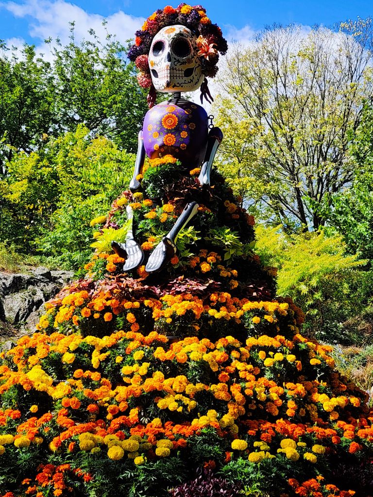 La Catrina, symbol of 'Dia de los Muertos,' with marigold array for ancestral remembrance NYBG, Everett's Children Adventure Garden (Carole Di Tosti)
